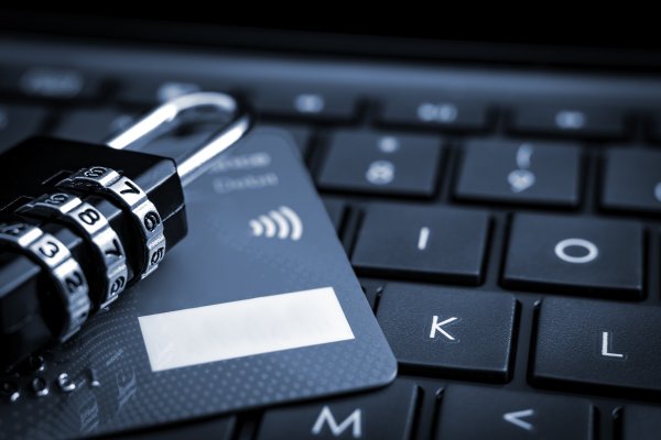 identity theft protection service lifelock identity guard lock on credit card on black computer keyboard